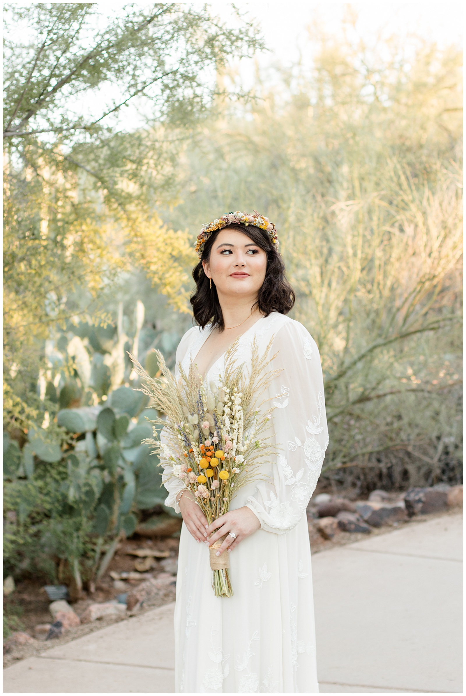 phoenix wedding photographer boho bride poses in front of cactus.