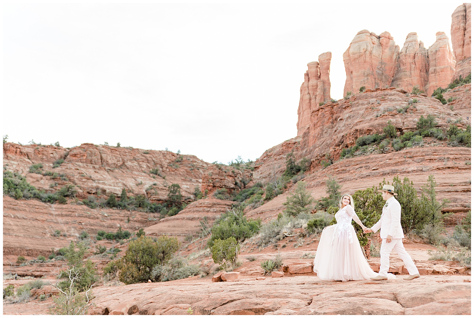 Stunning view of Cathedral Rock with elopement couple walking