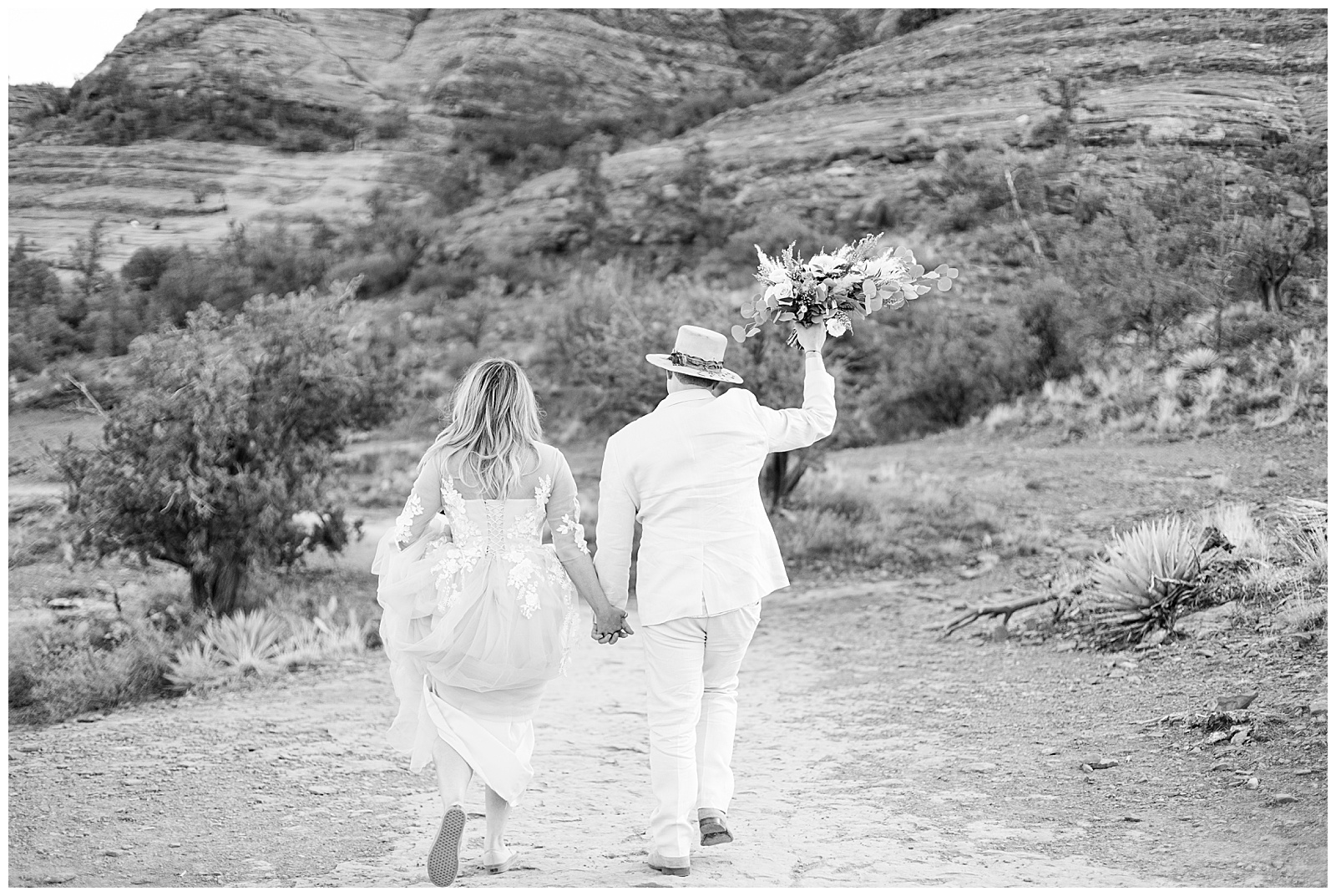 Bride and groom walking along the rocks