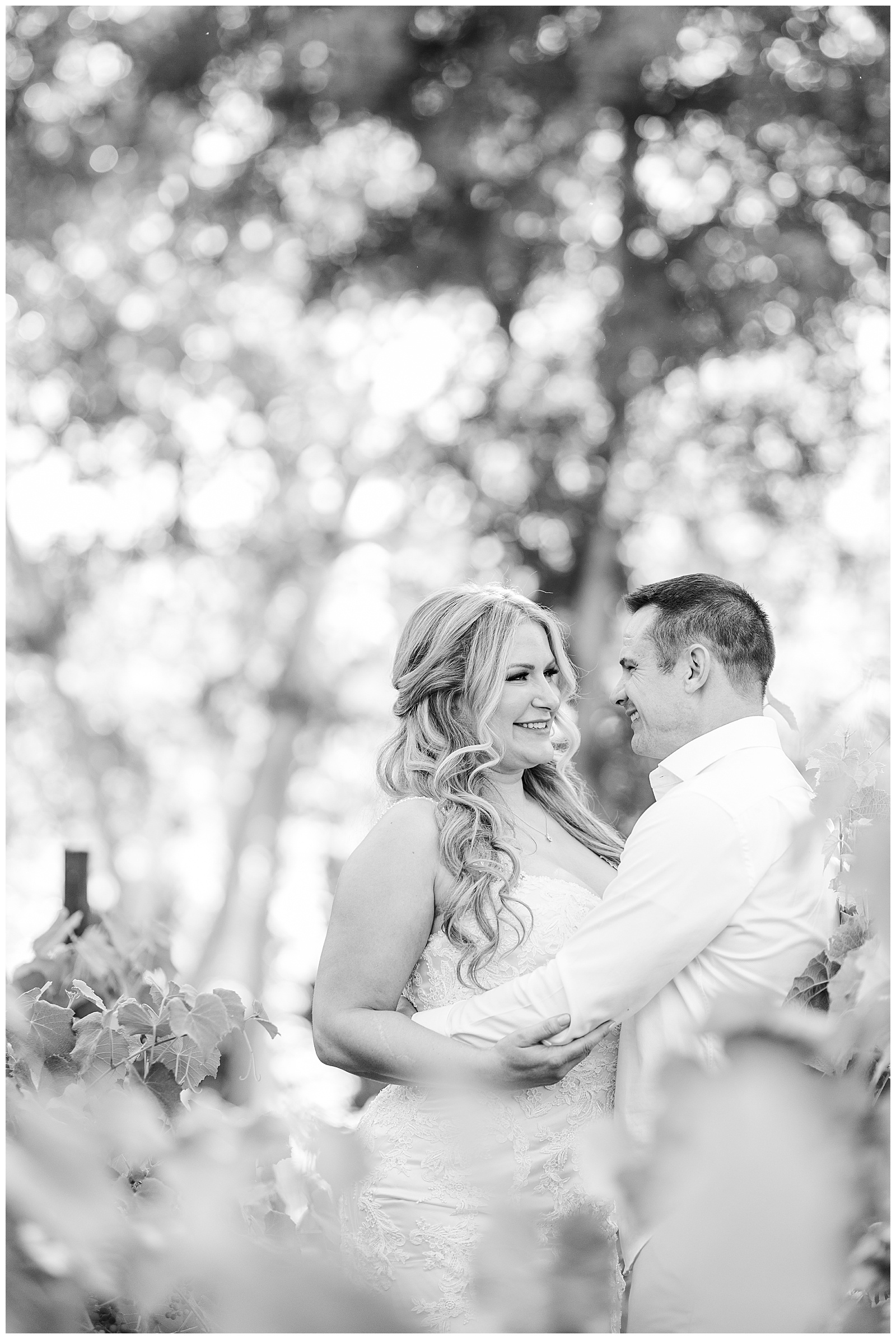 Elopement couple staring at each other in love in the vineyard