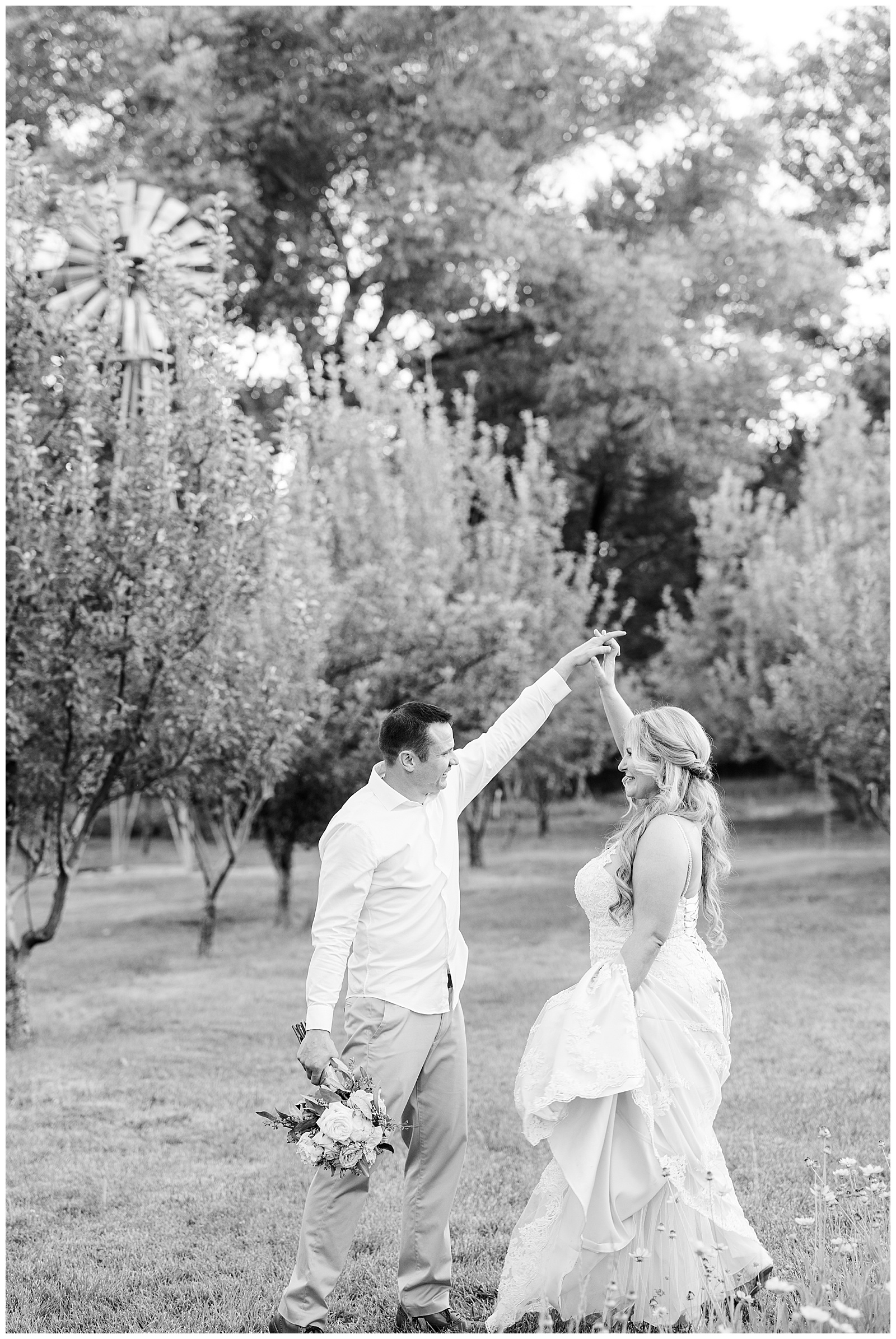 Bride and groom dancing in an apple orchard