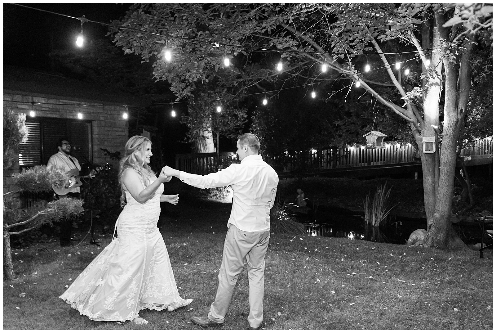 Bride and groom dancing under lights at their intimate wedding